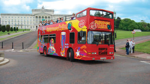 Tranquil journey through Belfast's streets: City Sightseeing Hop-on Hop-off bus offers passengers serene vibes, exploring the city's charm.